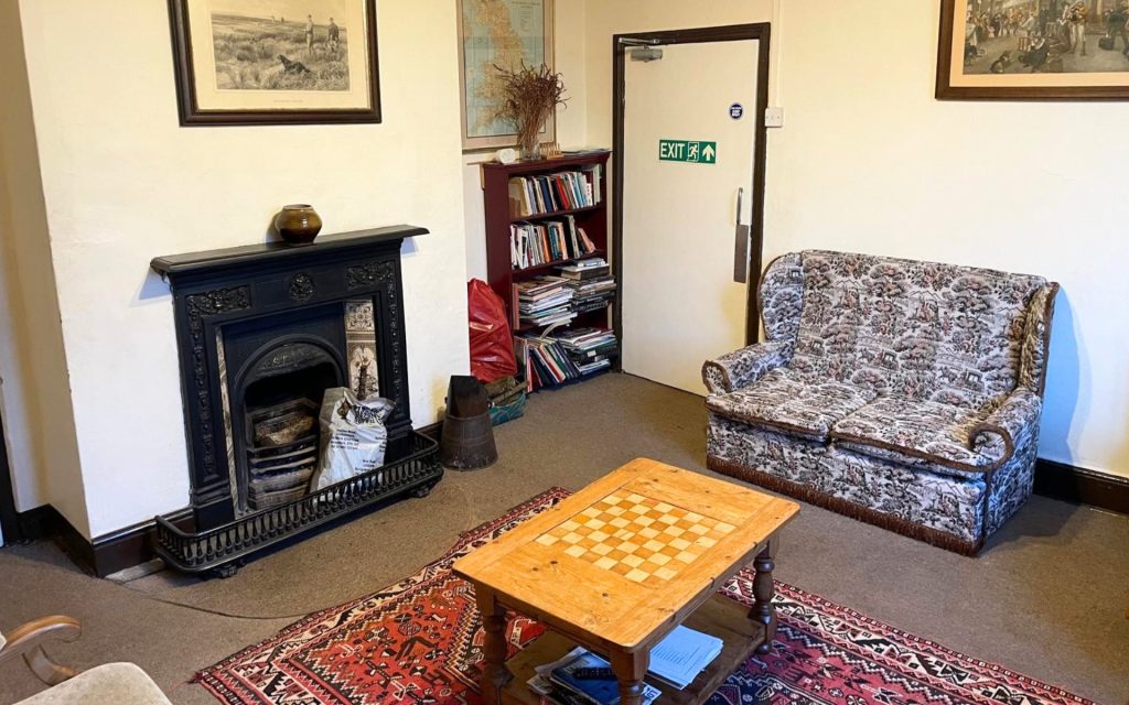 living room with sofas and real fire
